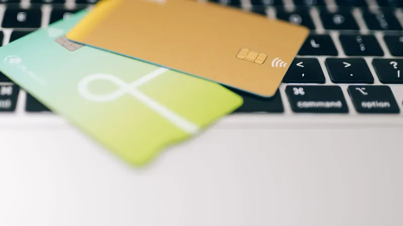 Two credit cards lying on a laptop keyboard