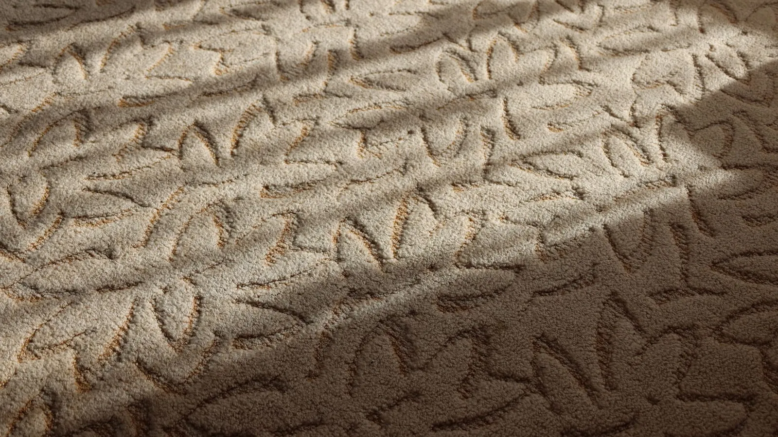 Close-up of a textured beige carpet in soft daylight
