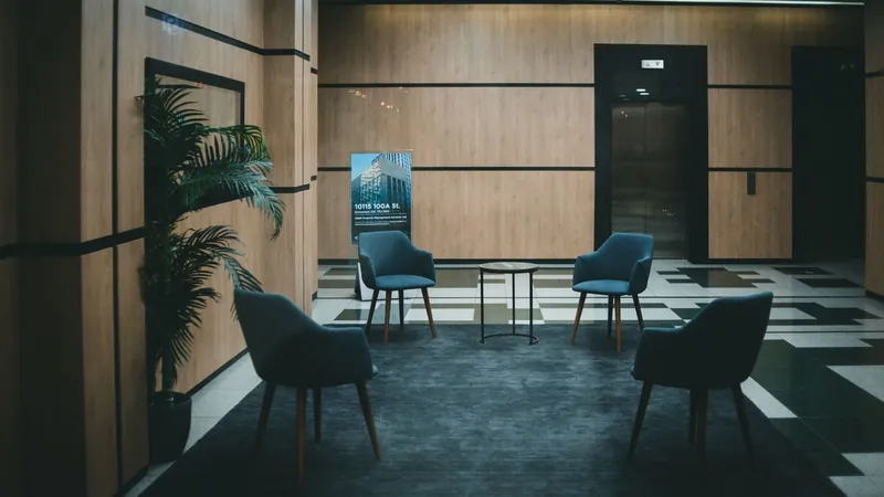 Office lobby with padded chairs and a neutral, minimal interior