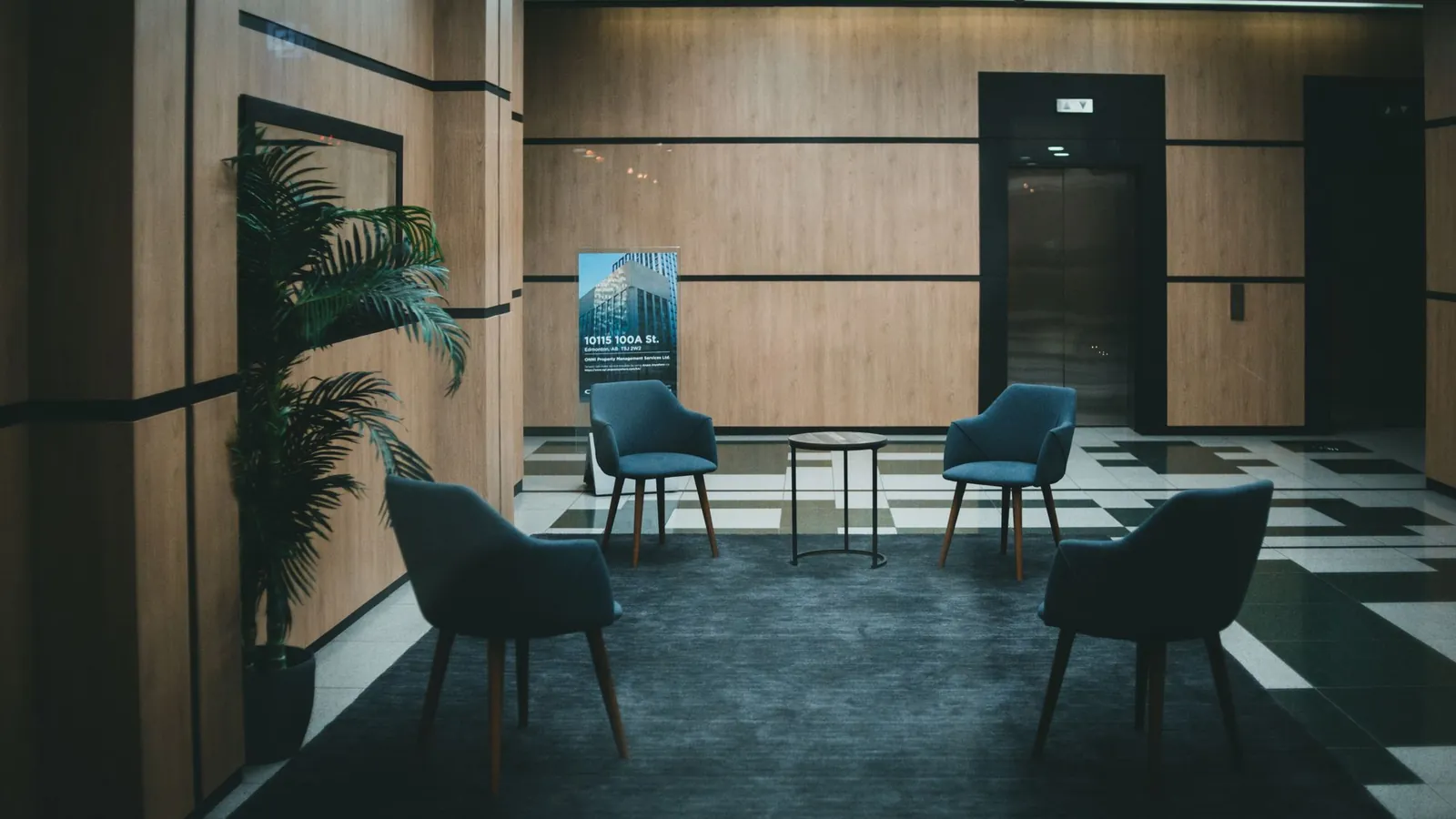Office lobby with padded chairs and a neutral, minimal interior