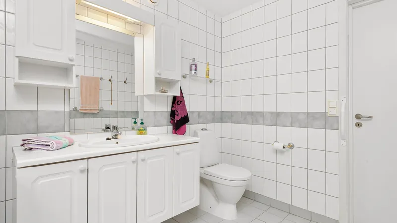 Bright modern bathroom with white tiles and simple fixtures