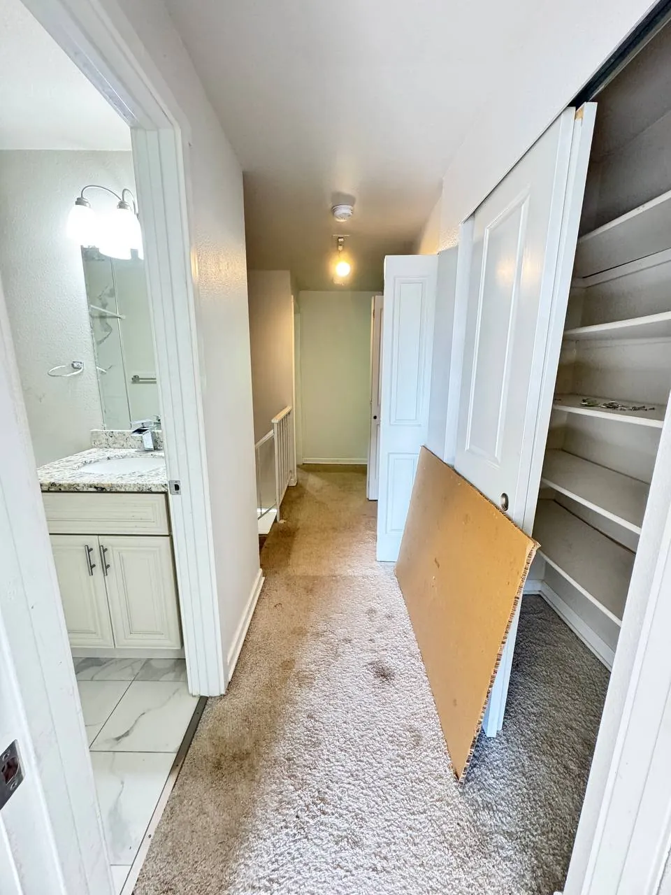 Before: upstairs hallway carpet between the bathroom and a closet