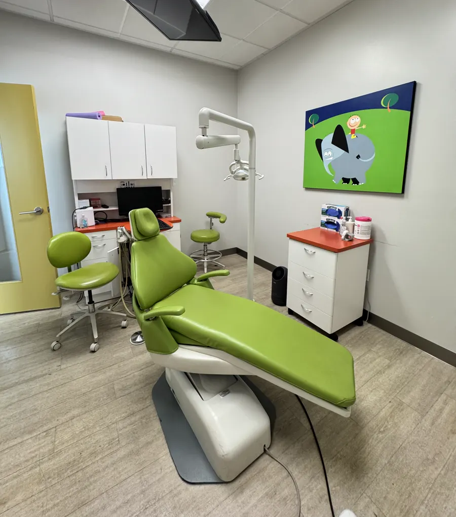 Private pediatric dental operatory with chair, carts and cabinets