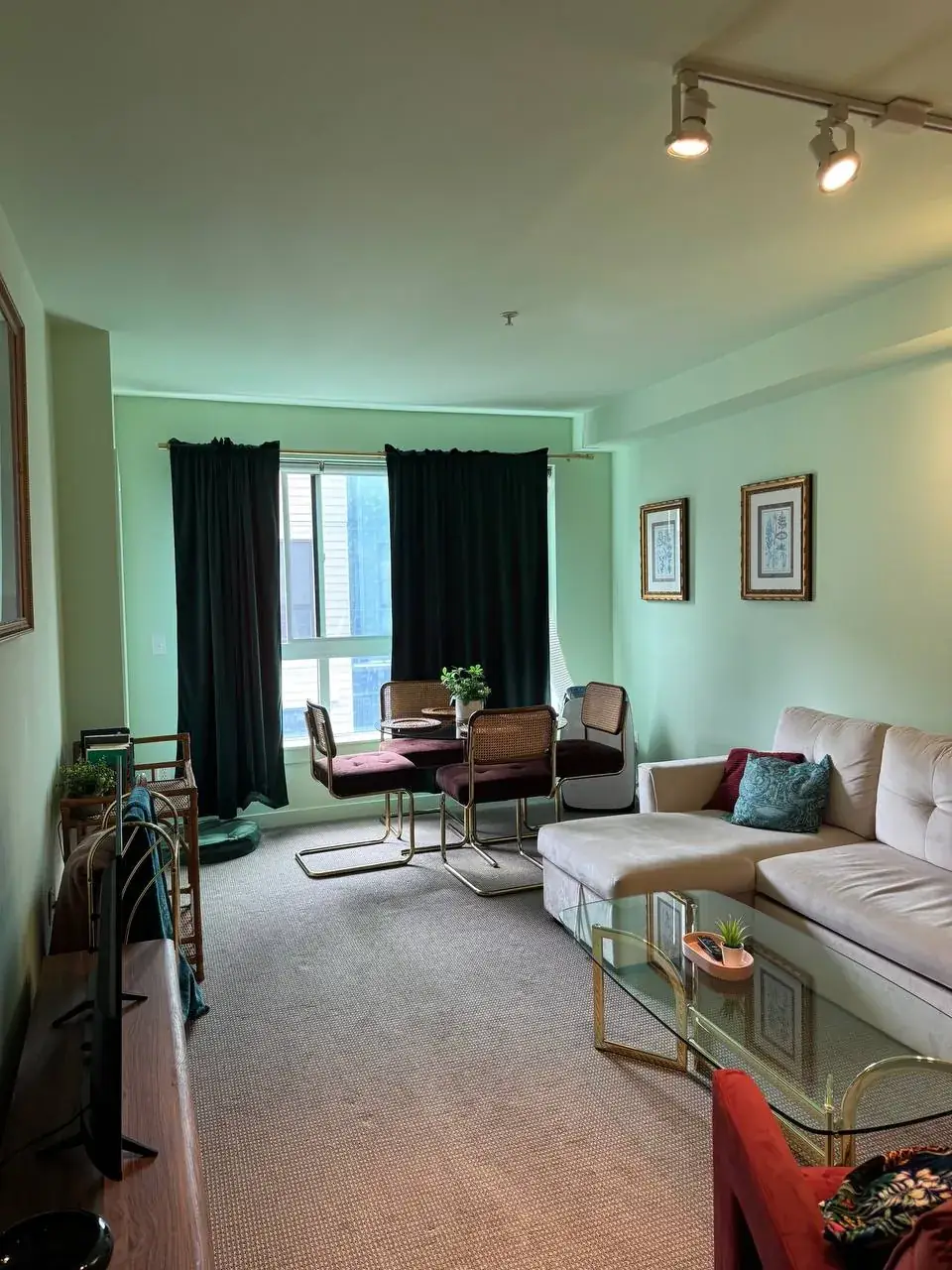 Before: living room with sectional sofa, glass coffee table and dining corner