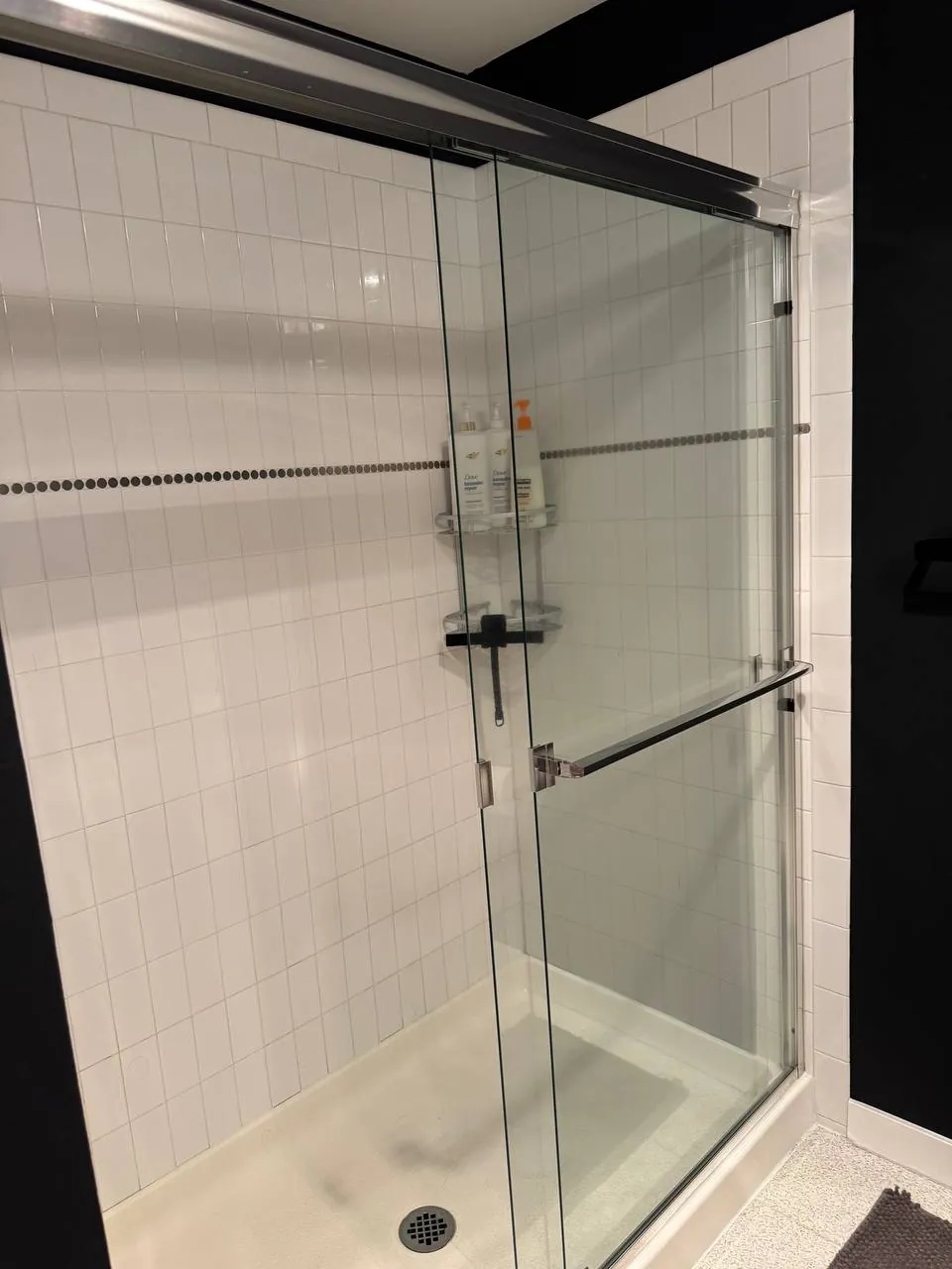 Before: walk-in shower with sliding glass doors