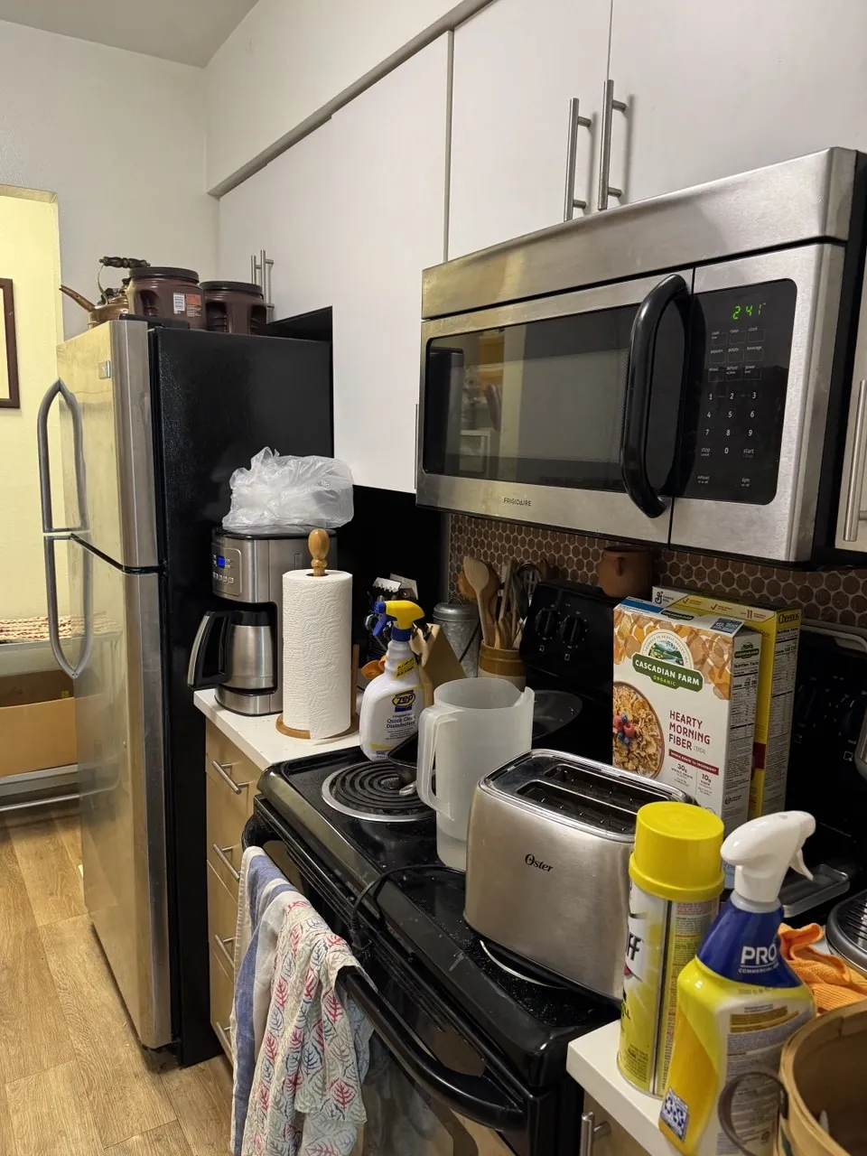 Before: kitchen counter, electric range and microwave