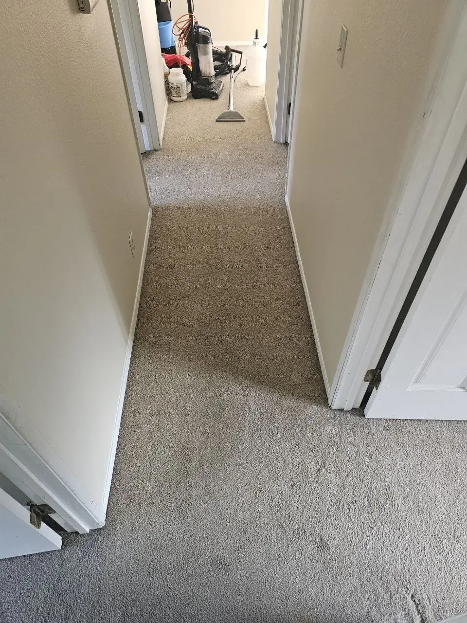 Before: vacant rental upstairs hallway carpet between bedroom doors