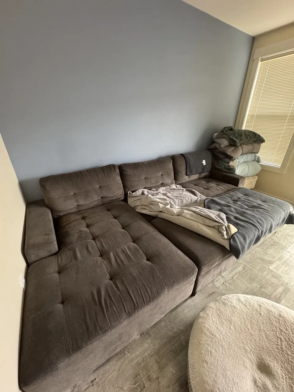 Before: gray fabric sectional with tufted seat cushions
