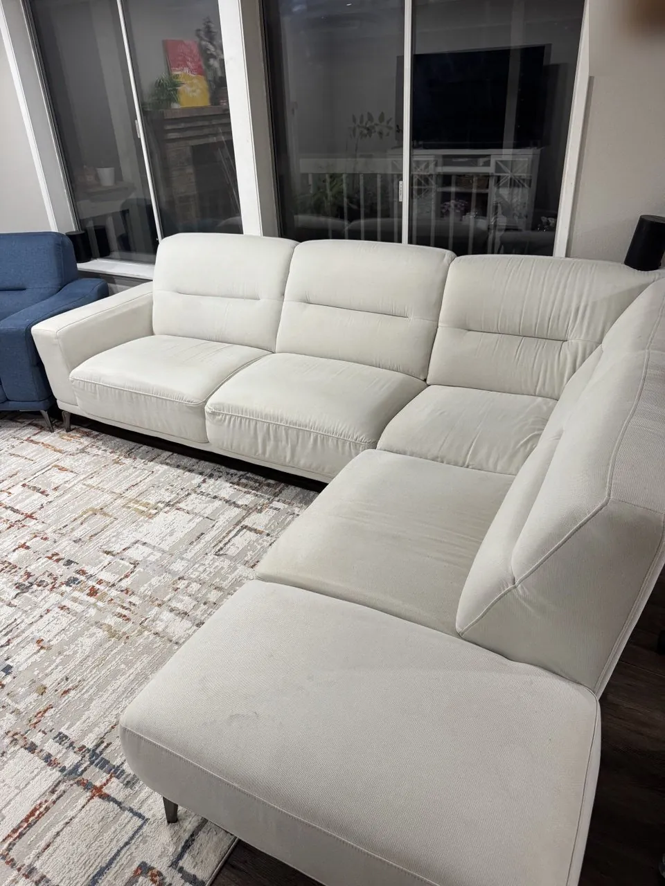 Before: white fabric sectional with a stained chaise seat